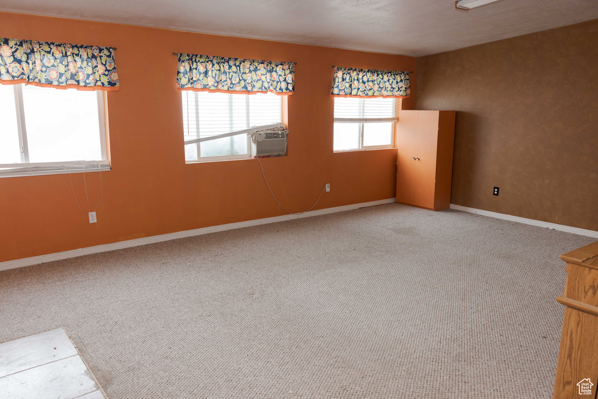 Carpeted empty room with cooling unit