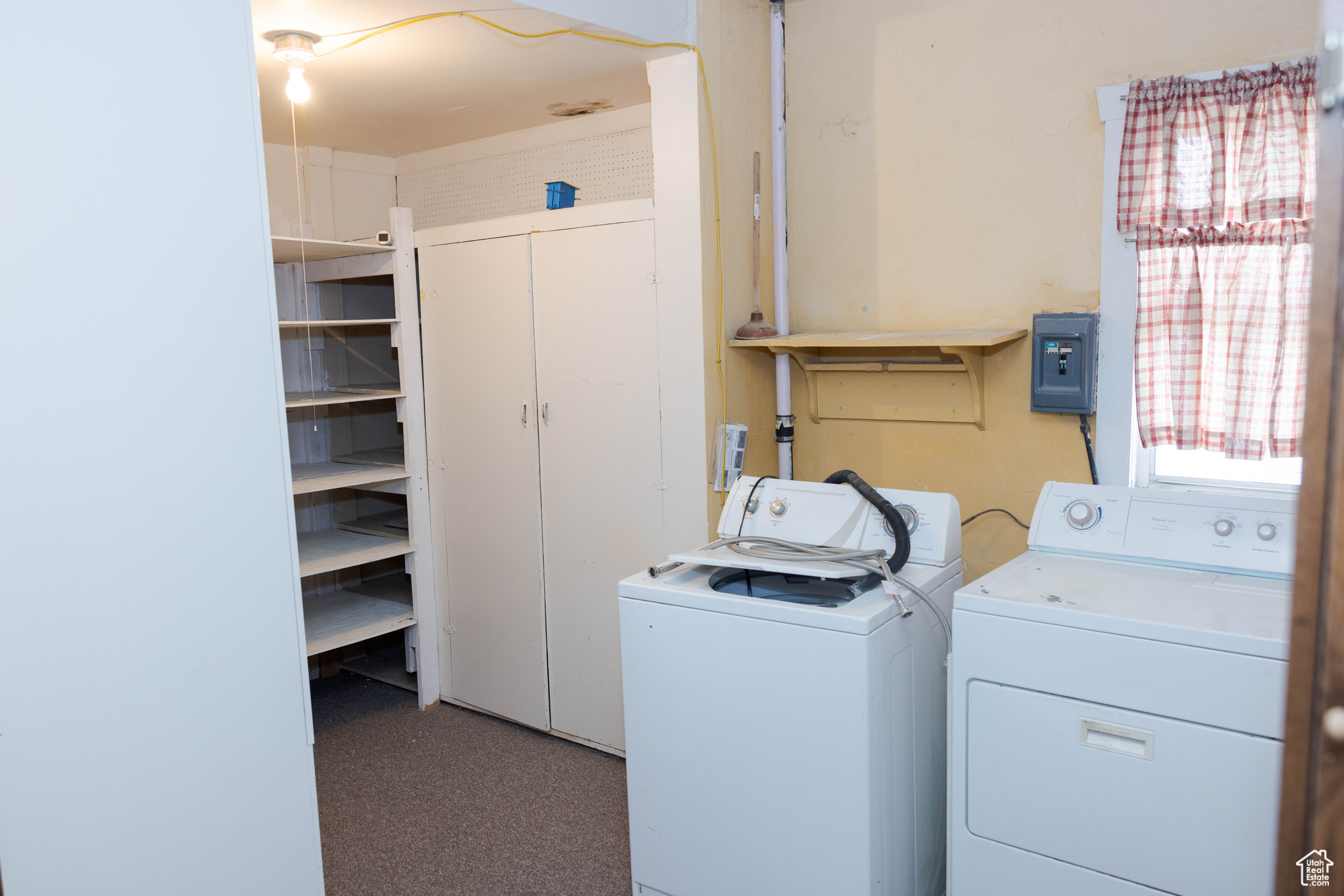 Clothes washing area featuring separate washer and dryer