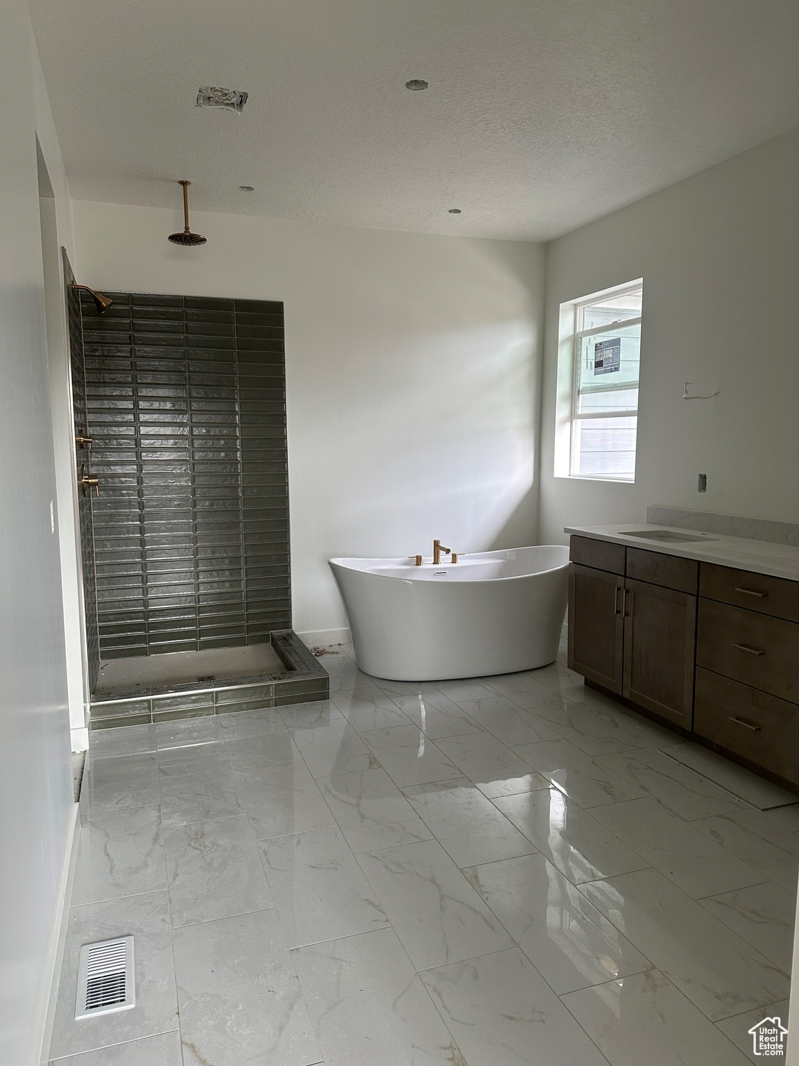 Bathroom featuring plus walk in shower and vanity