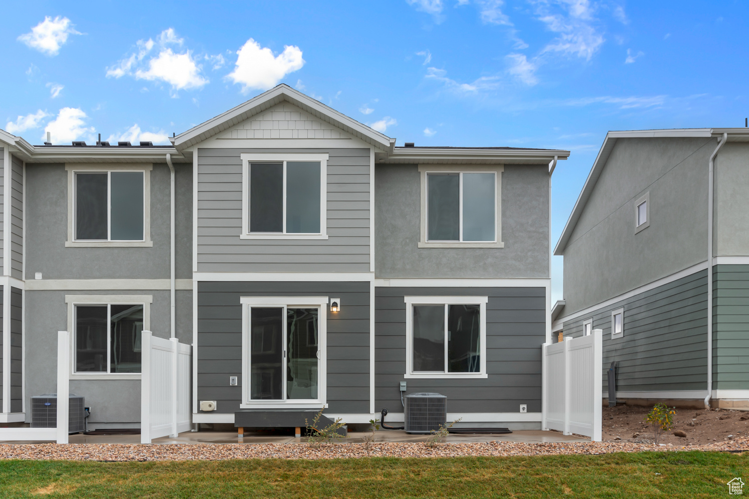 Back of house featuring a lawn and central AC unit