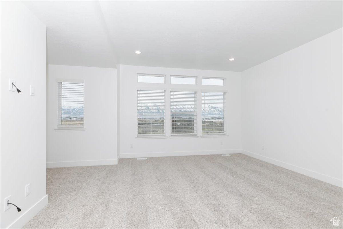 Carpeted empty room with a healthy amount of sunlight