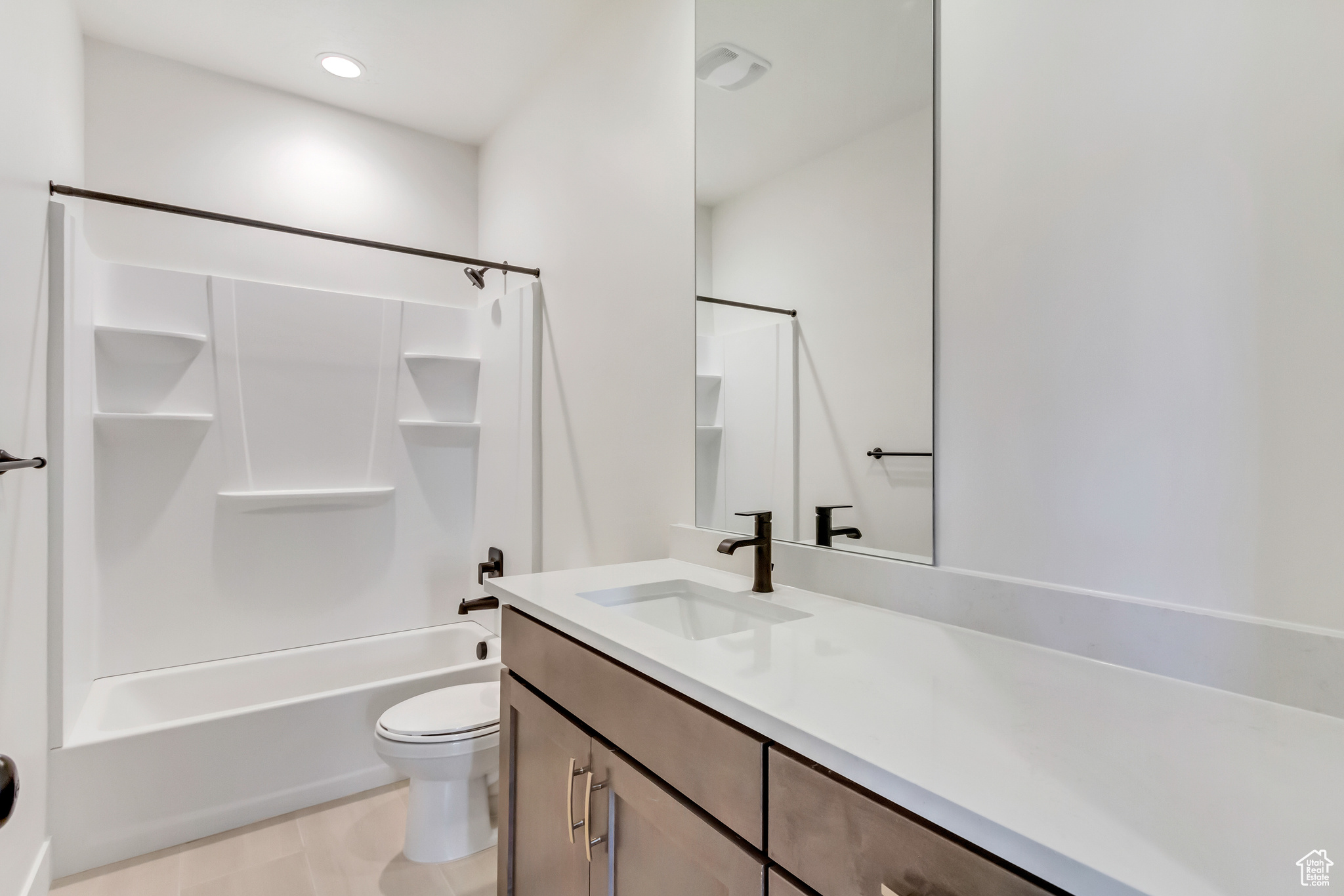 Full bathroom featuring vanity, toilet, and tub / shower combination