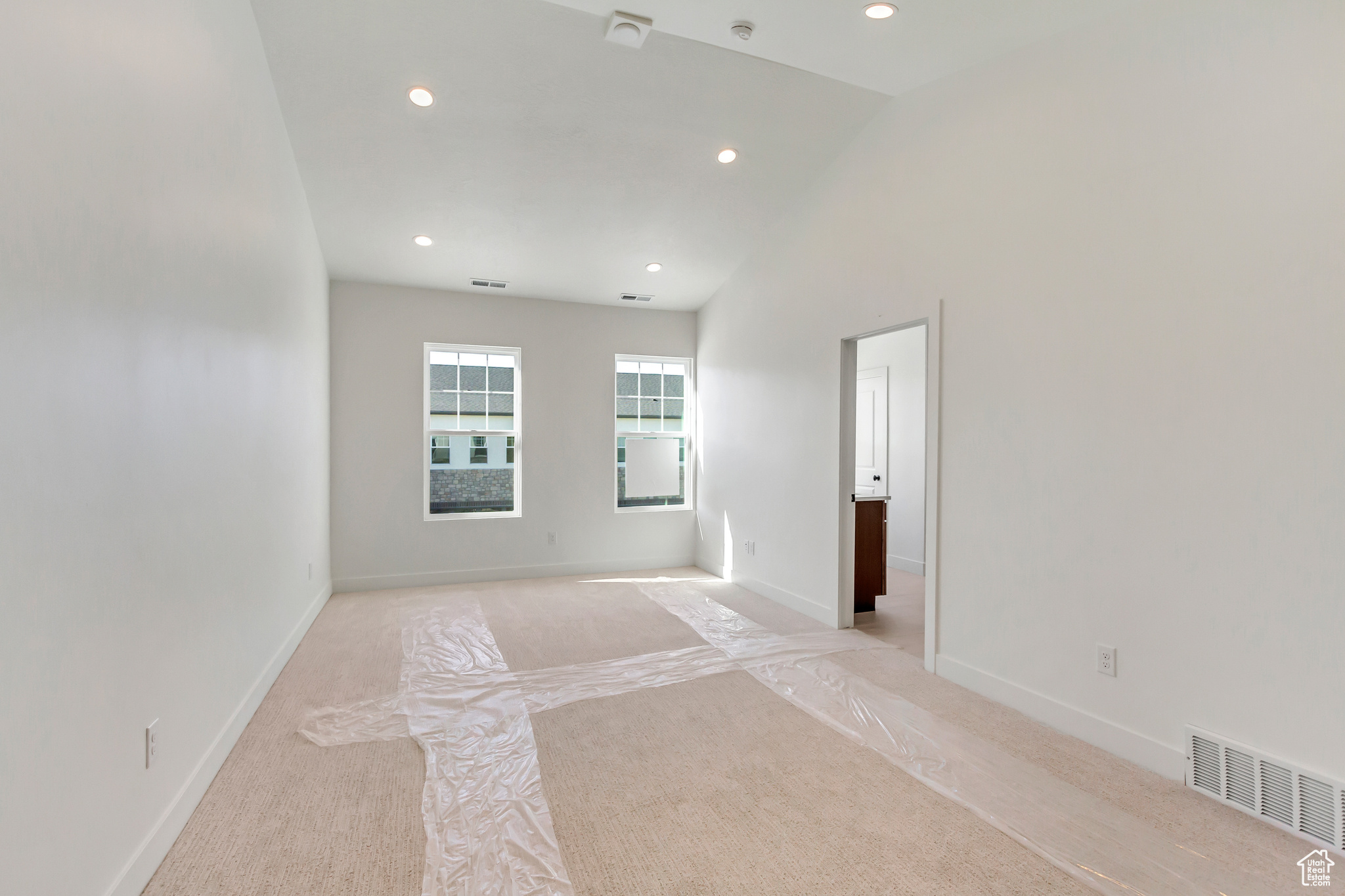 Unfurnished room with lofted ceiling