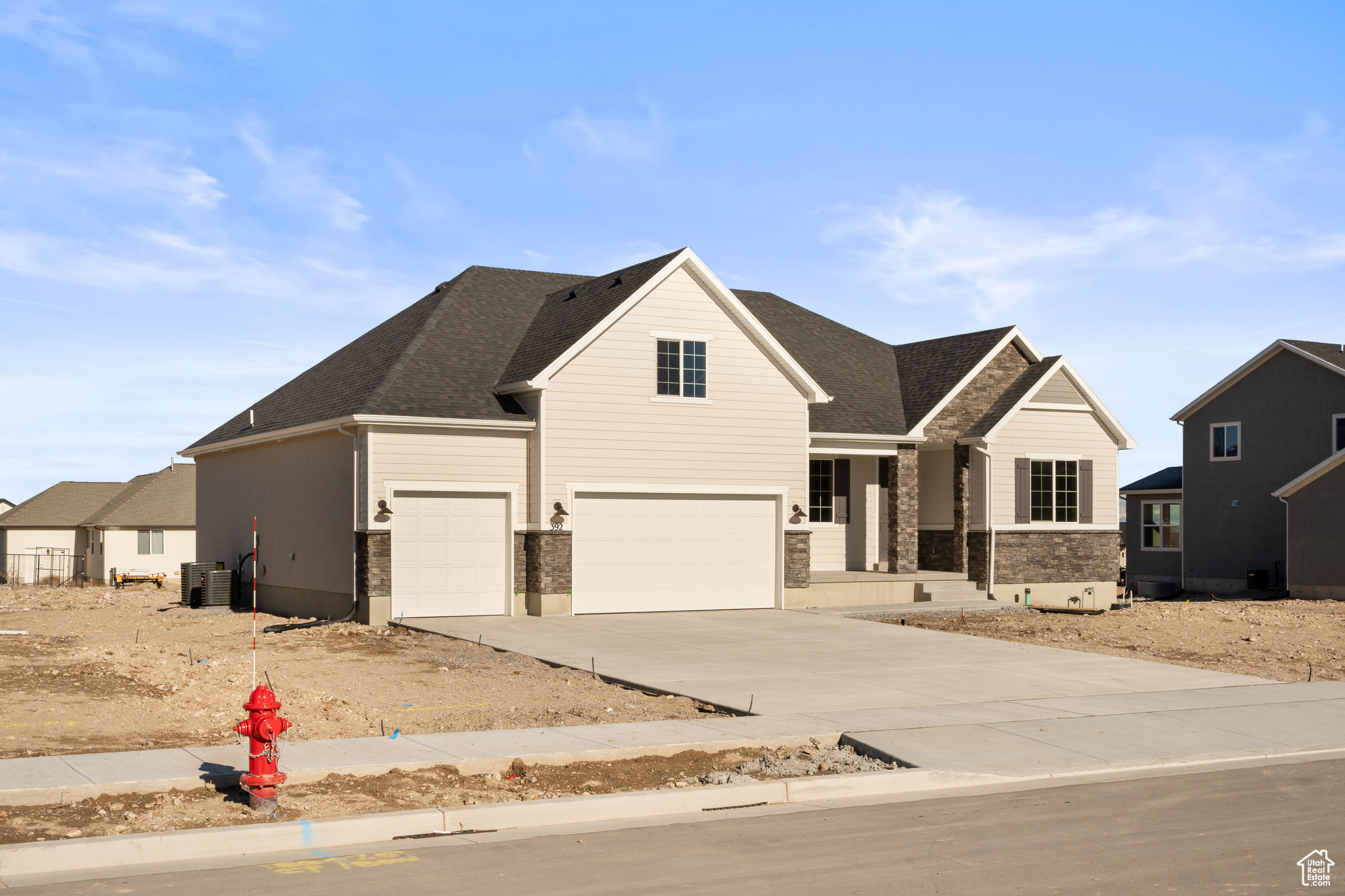 View of front of property featuring cooling unit and a garage