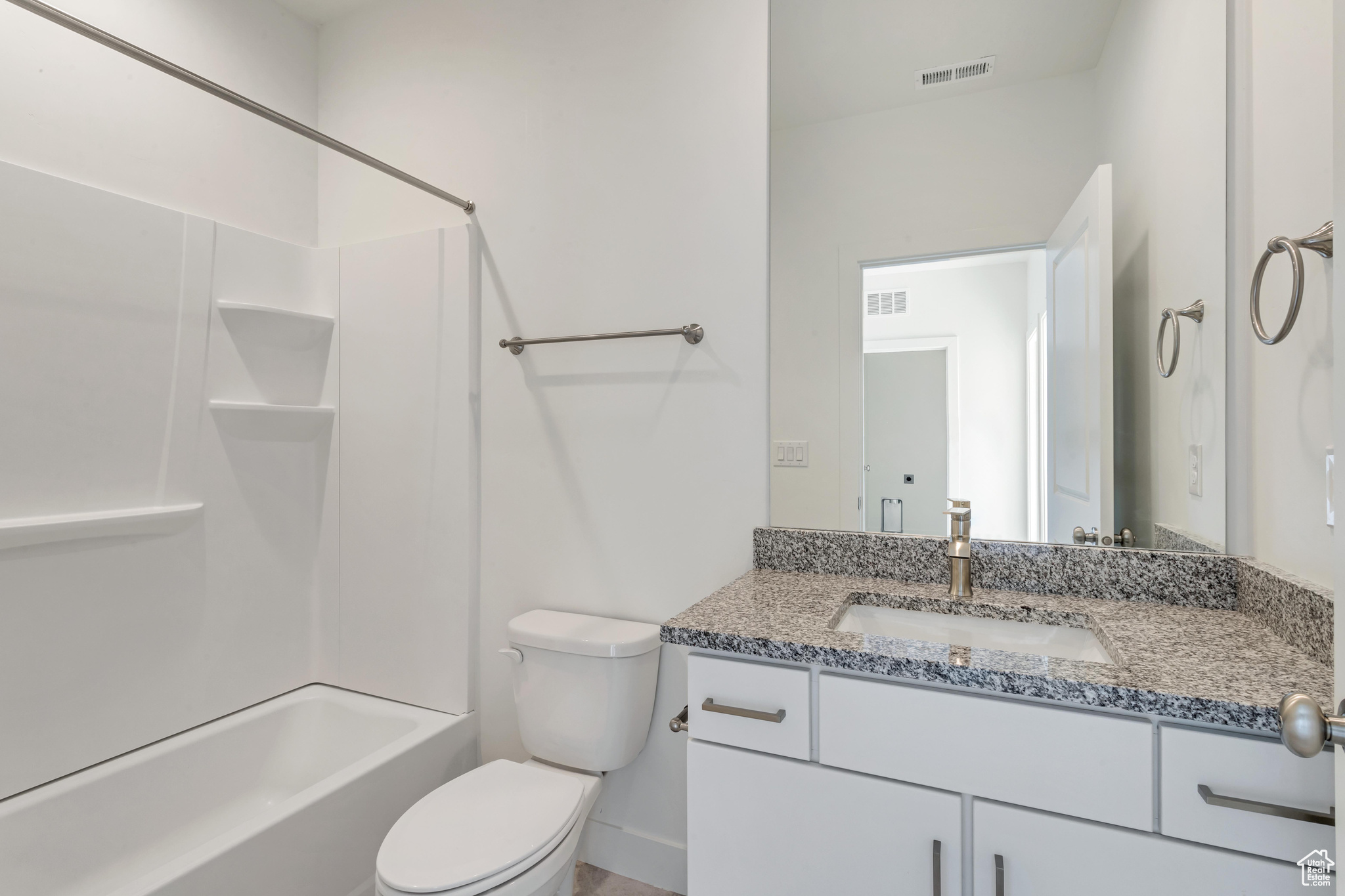 Full bathroom with shower / bathing tub combination, vanity, and toilet