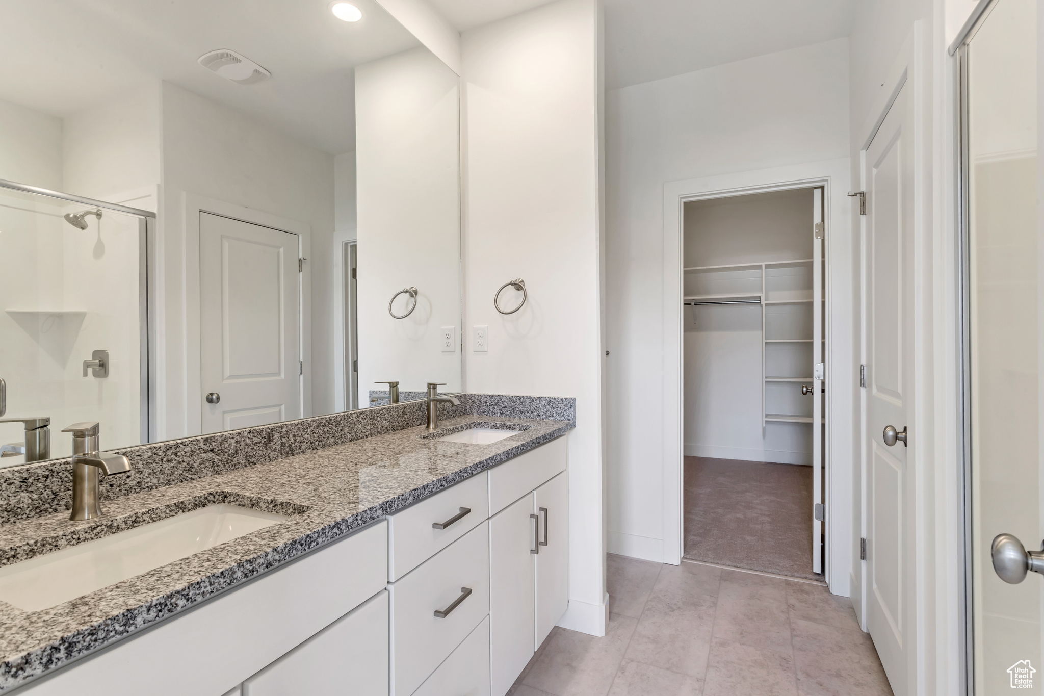 Bathroom featuring vanity and an enclosed shower