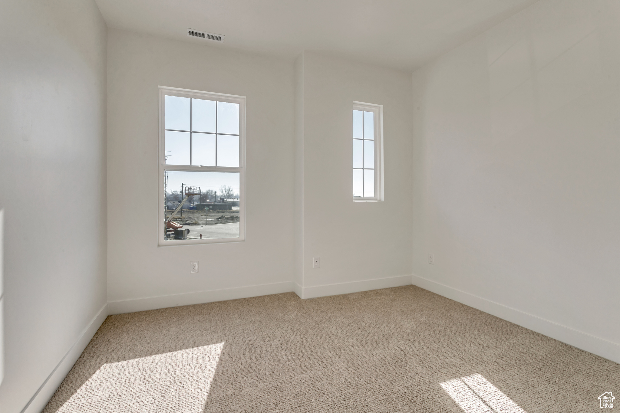 Carpeted spare room with a healthy amount of sunlight