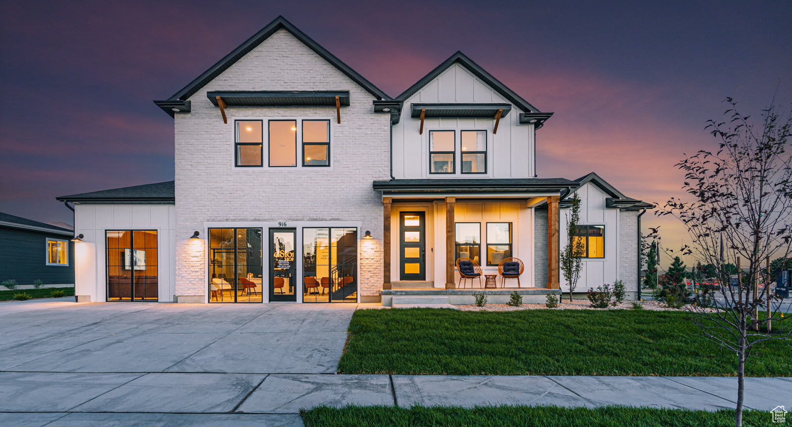 Modern farmhouse with a porch and a lawn