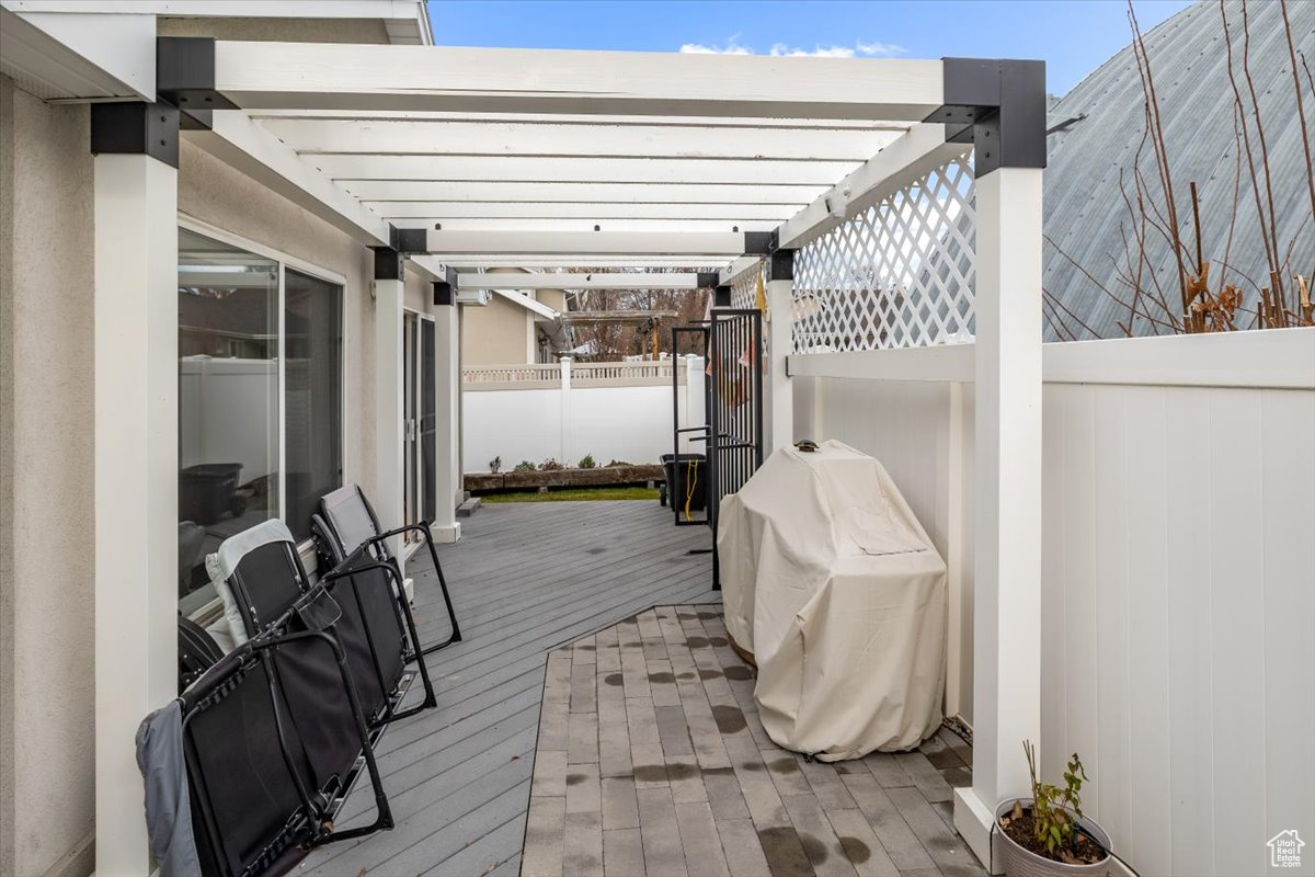 Deck featuring a pergola and grilling area