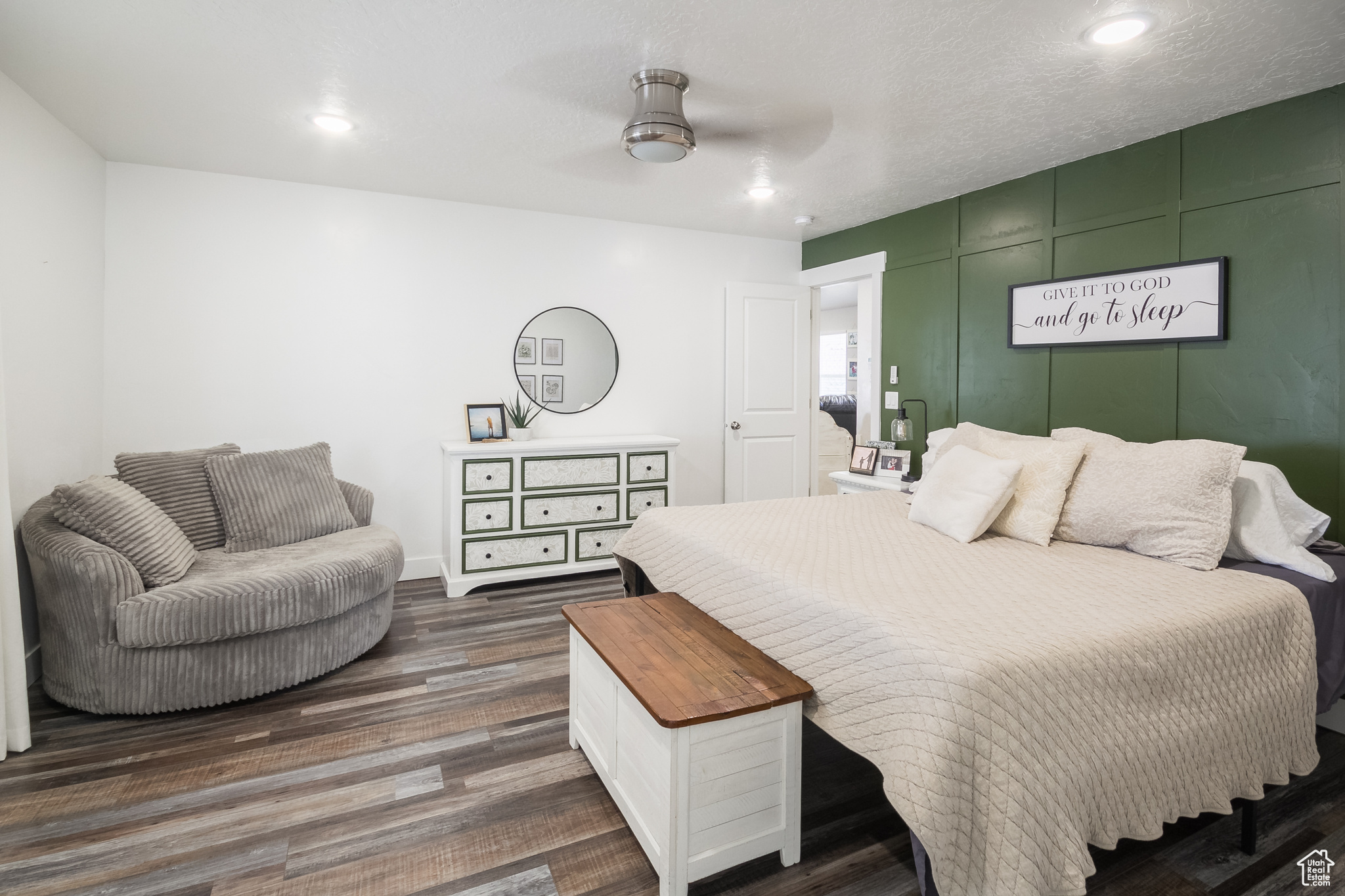 Bedroom with a textured ceiling, ceiling fan, and dark wood-type flooring