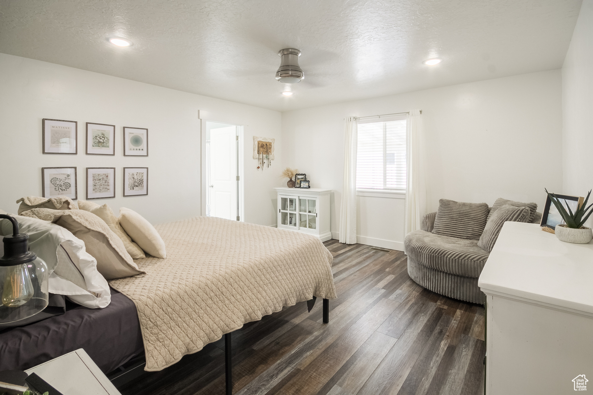 Bedroom with ceiling fan, dark hardwood / wood-style flooring, and a textured ceiling