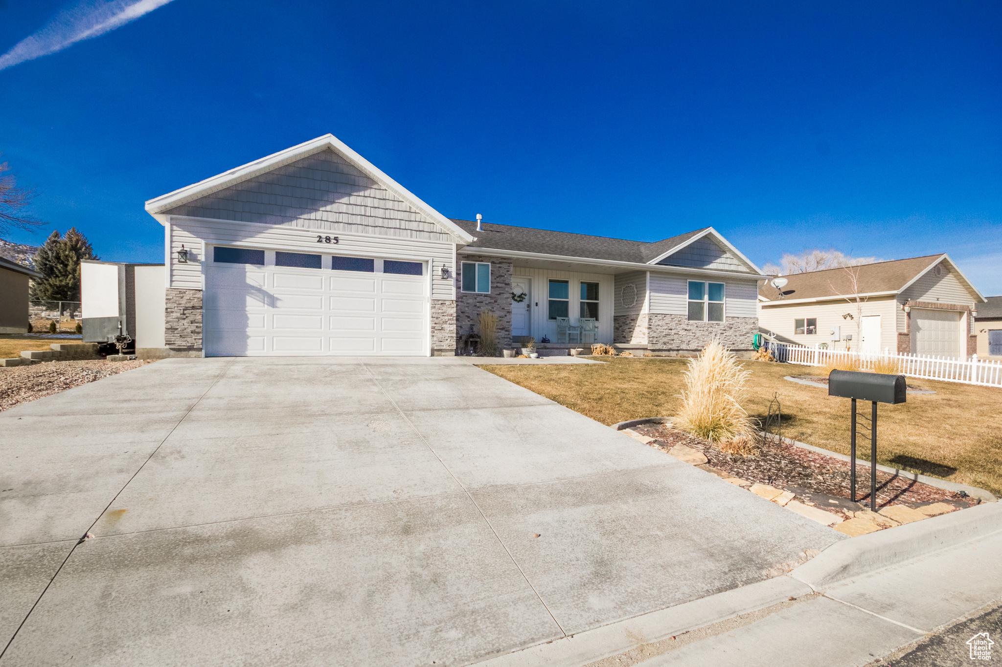 Ranch-style home with a garage and a front yard