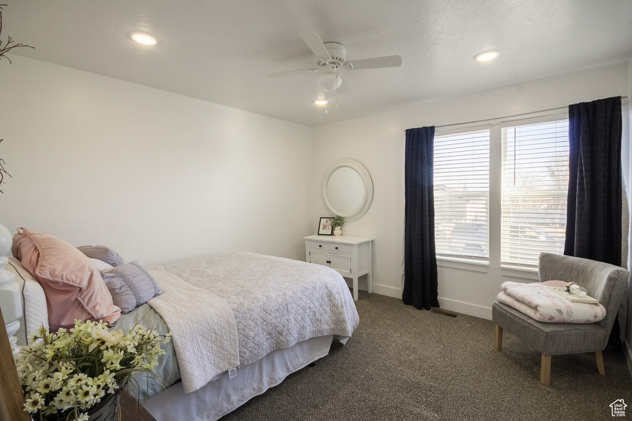 Bedroom featuring ceiling fan and carpet floors