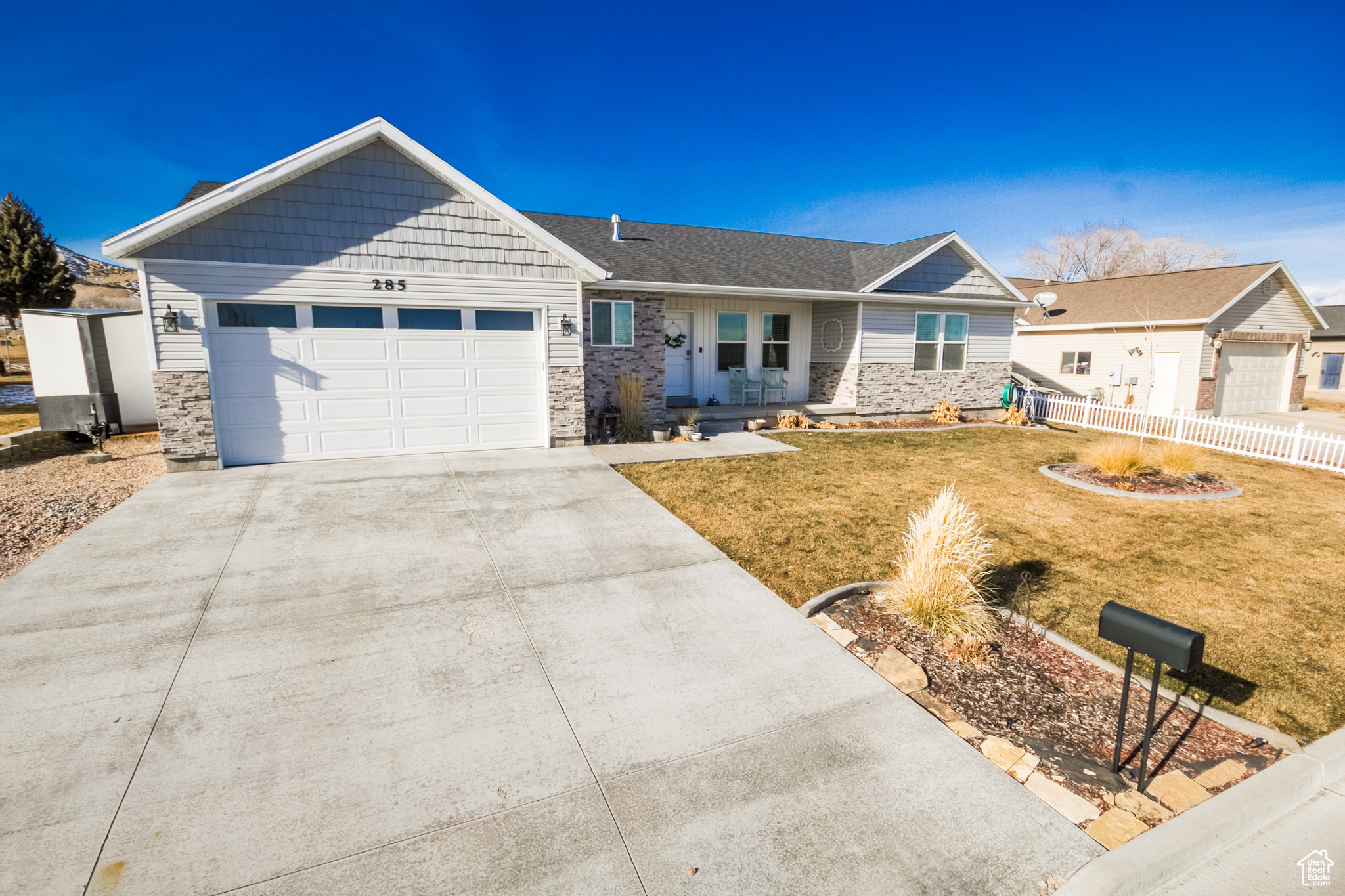 View of front of home with a front yard and a garage