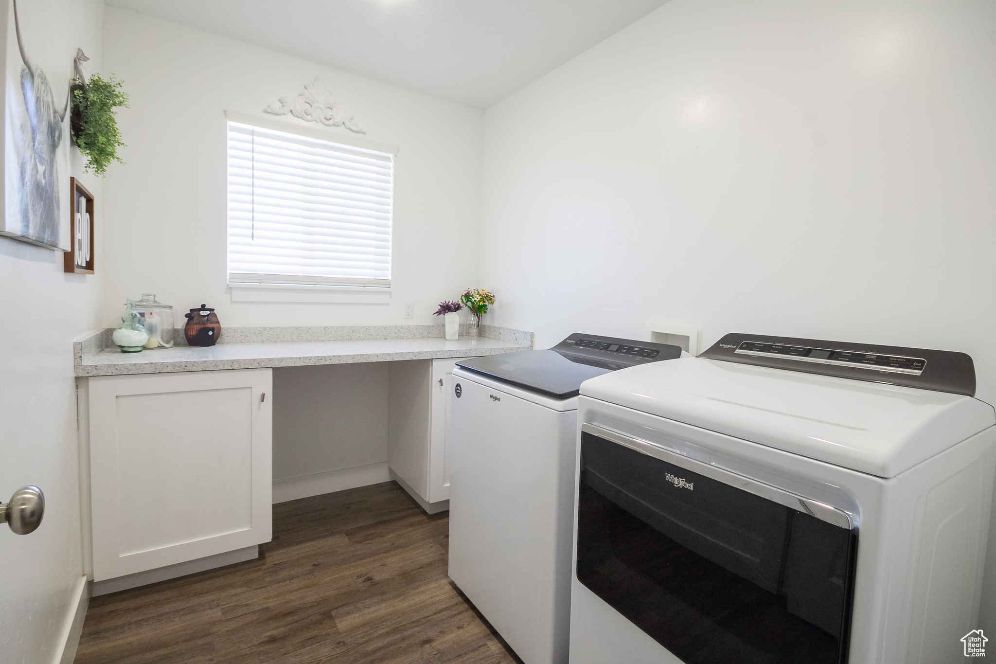 Clothes washing area with independent washer and dryer and dark hardwood / wood-style flooring