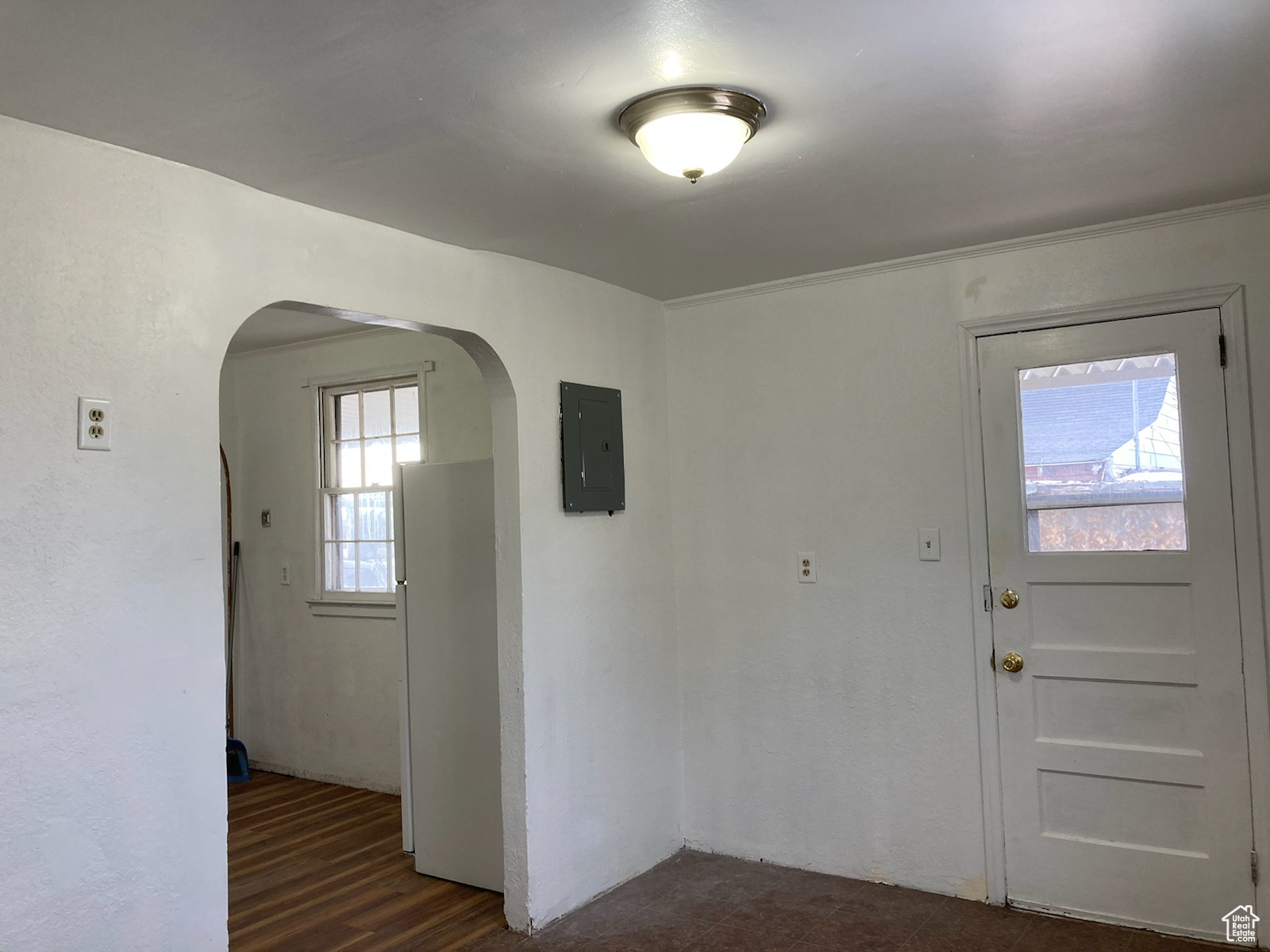 Foyer with electric panel and dark hardwood / wood-style flooring