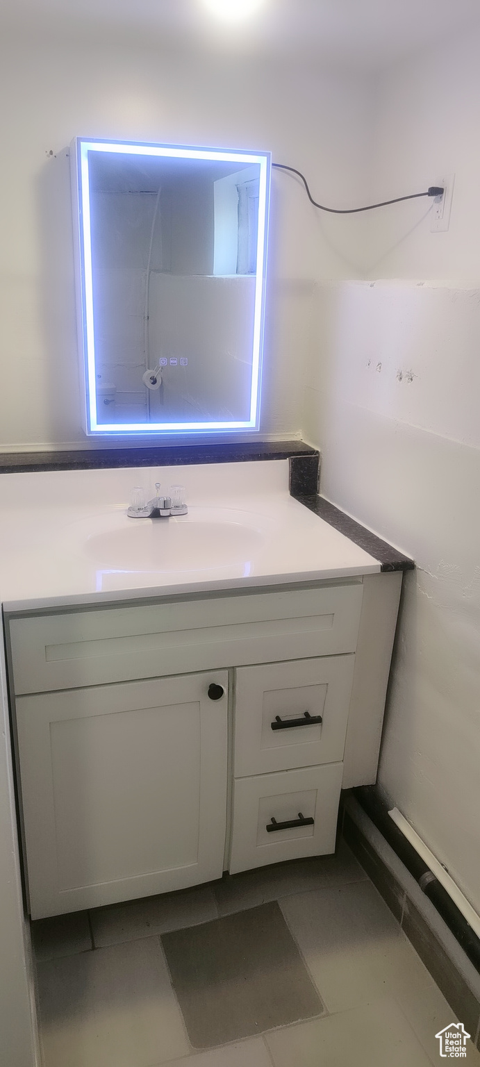 Bathroom with tile patterned flooring and vanity