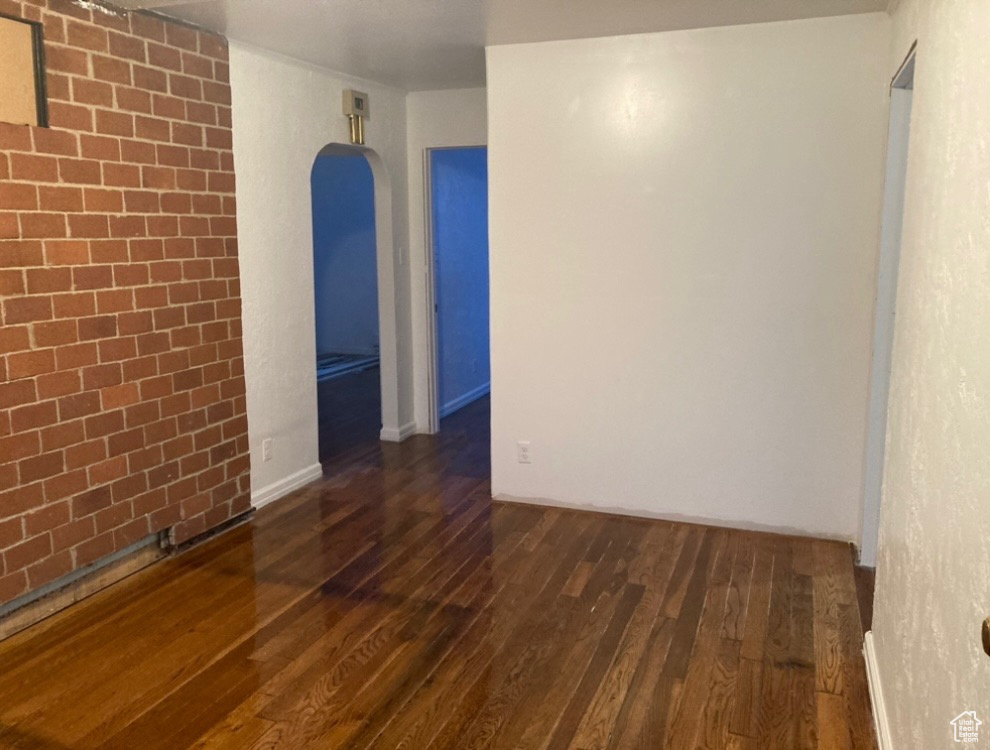 Spare room with dark wood-type flooring