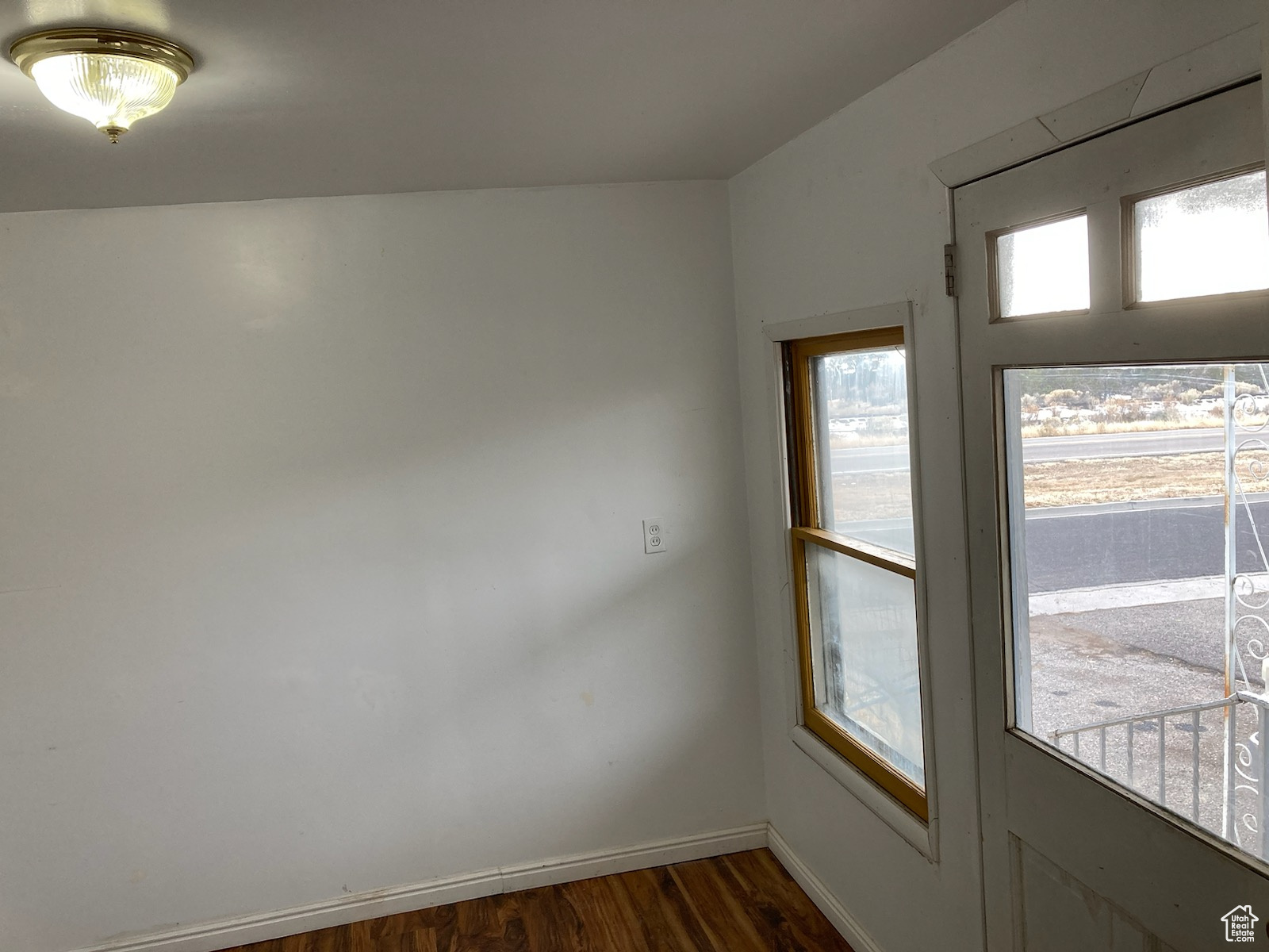 Entryway with dark hardwood / wood-style flooring