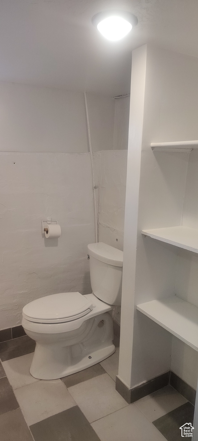 Bathroom featuring tile patterned flooring and toilet