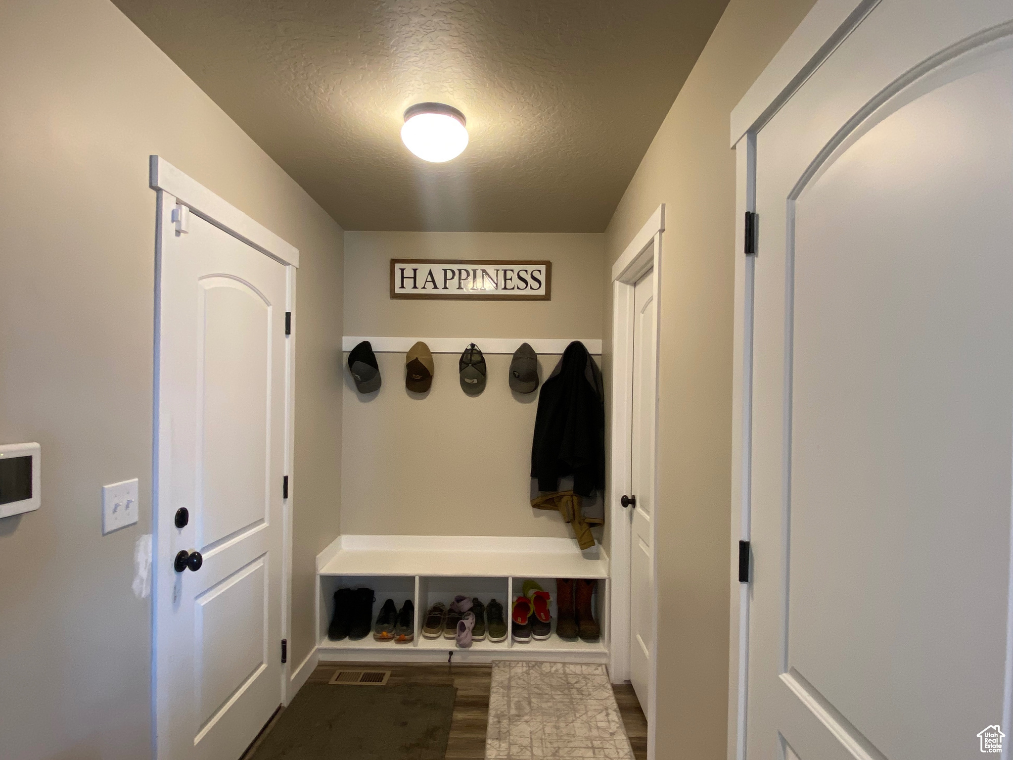 Mudroom featuring a textured ceiling