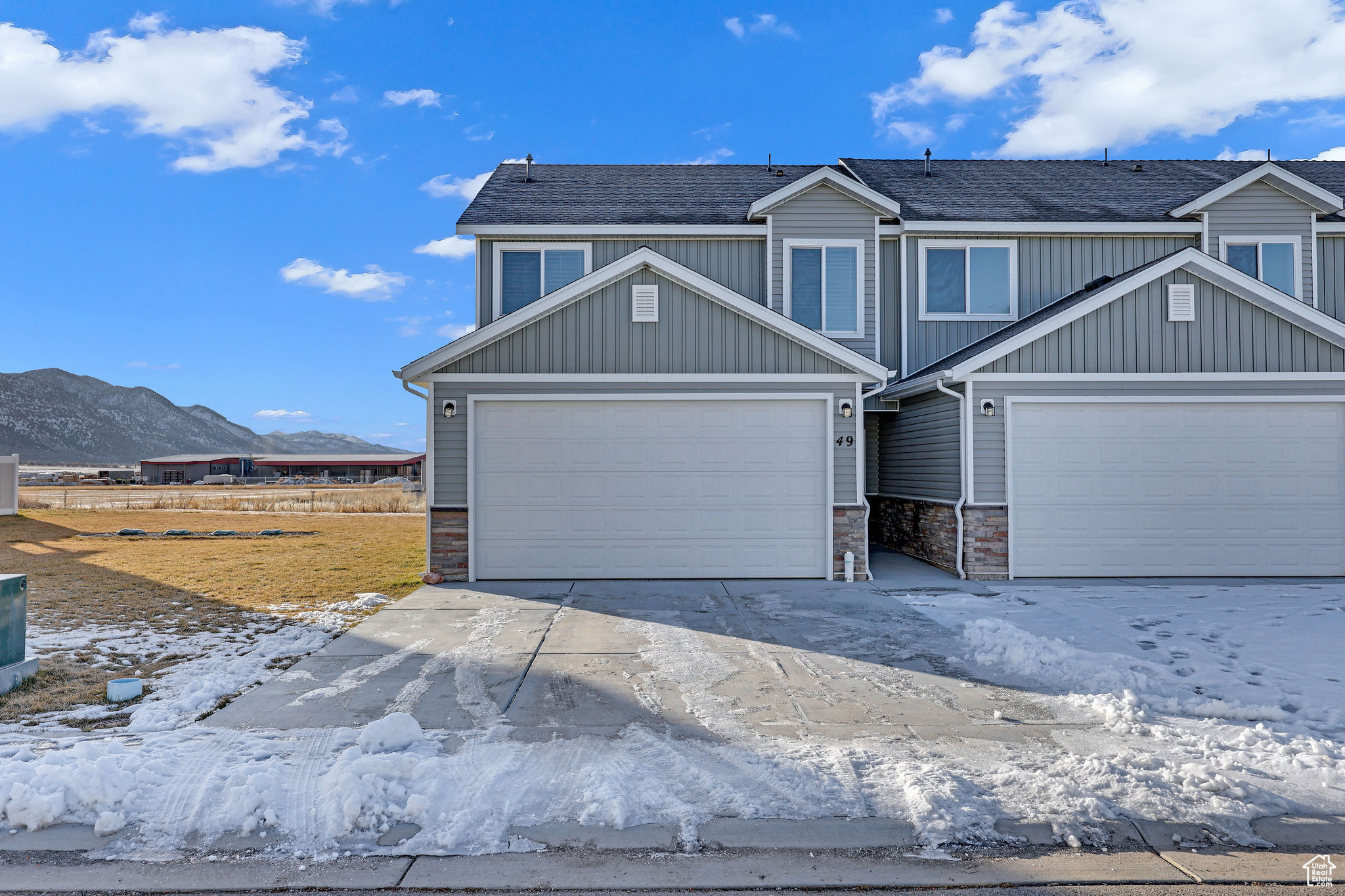 View of front facade with a mountain view and a garage