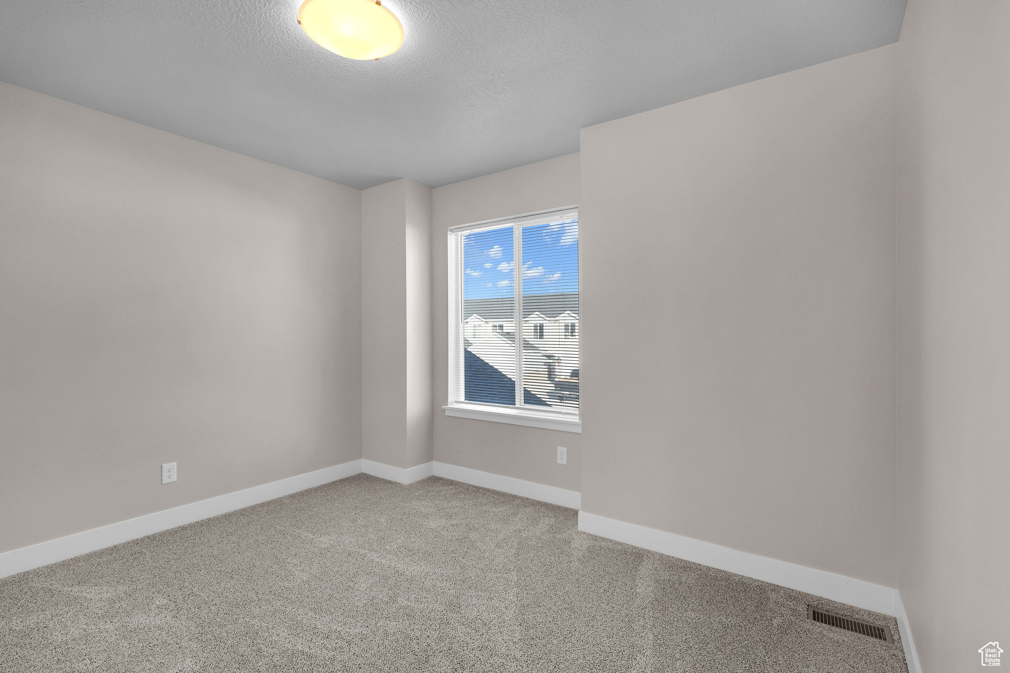 Empty room with carpet flooring