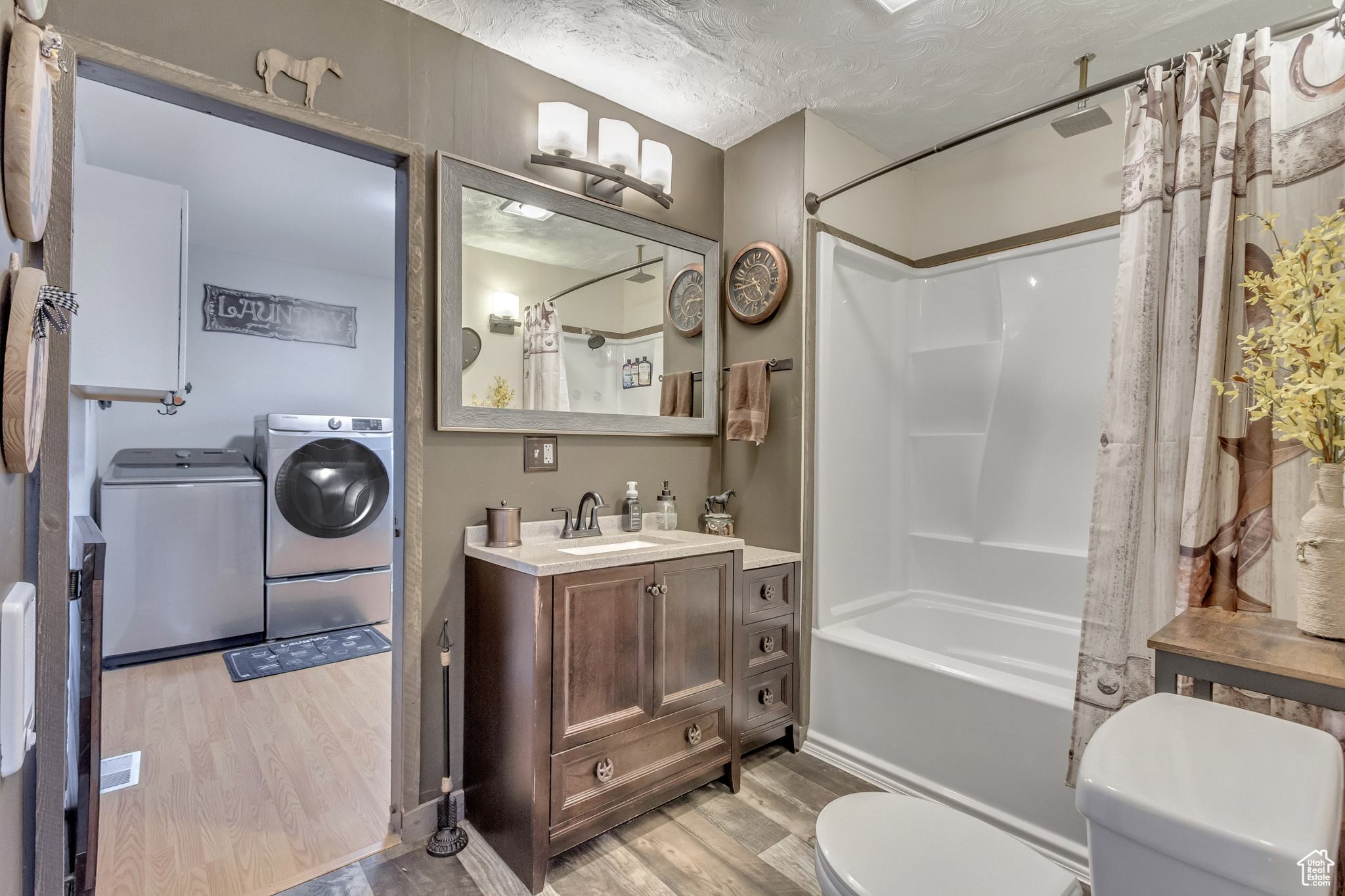 Full bathroom featuring shower / bath combo, LVP flooring, updated fixtures