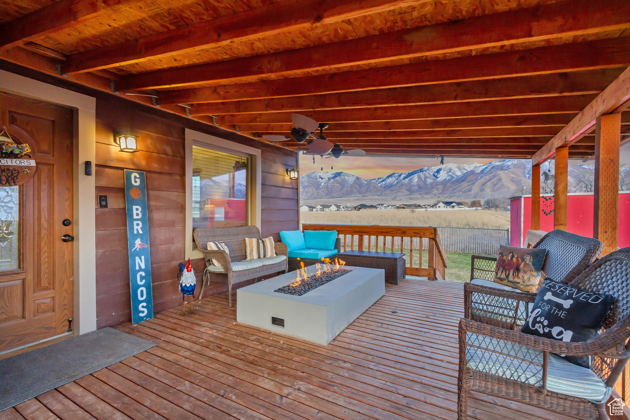 Deck featuring a mountain view and an outdoor living space with a fire pit