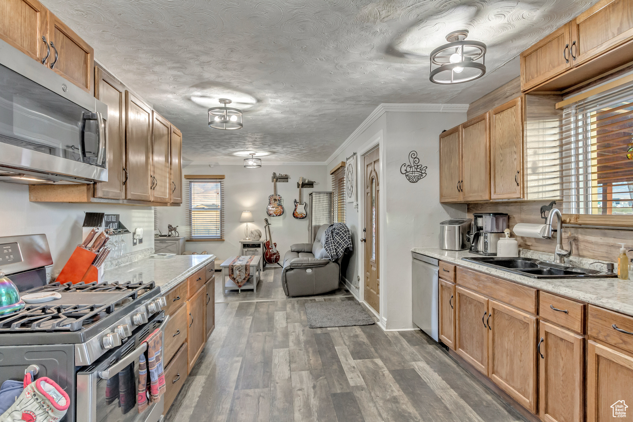 Kitchen featuring LVP flooring, granite counters and stainless steel appliances