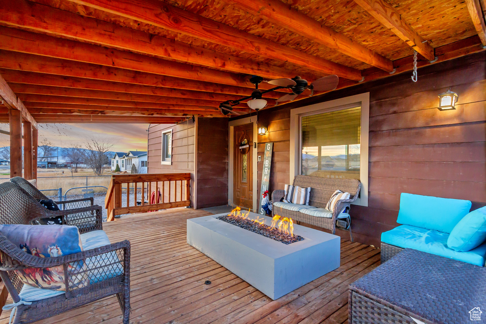 Deck at dusk featuring an outdoor living space with a fire pit and ceiling fan