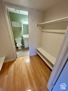 Bathroom with vanity, wood-type flooring, and toilet