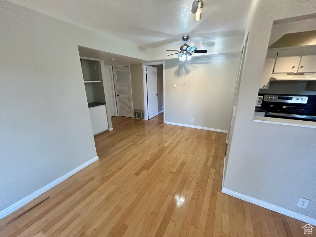 Interior space with ceiling fan and light hardwood / wood-style flooring