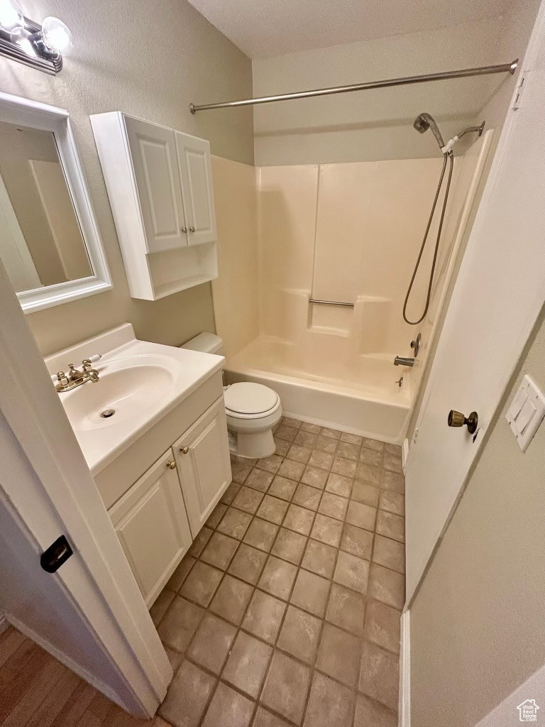 Full bathroom with vanity, bathing tub / shower combination, and toilet