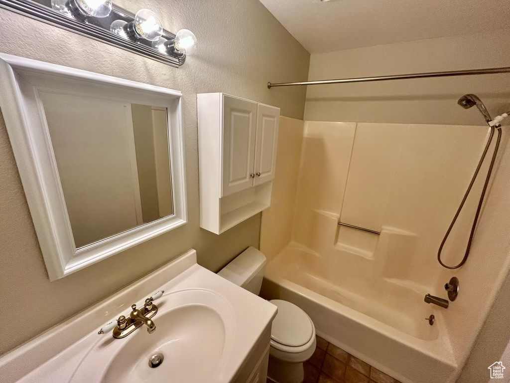 Full bathroom featuring  shower combination, toilet, and sink