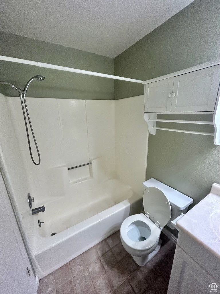 Full bathroom featuring toilet, vanity, and washtub / shower combination