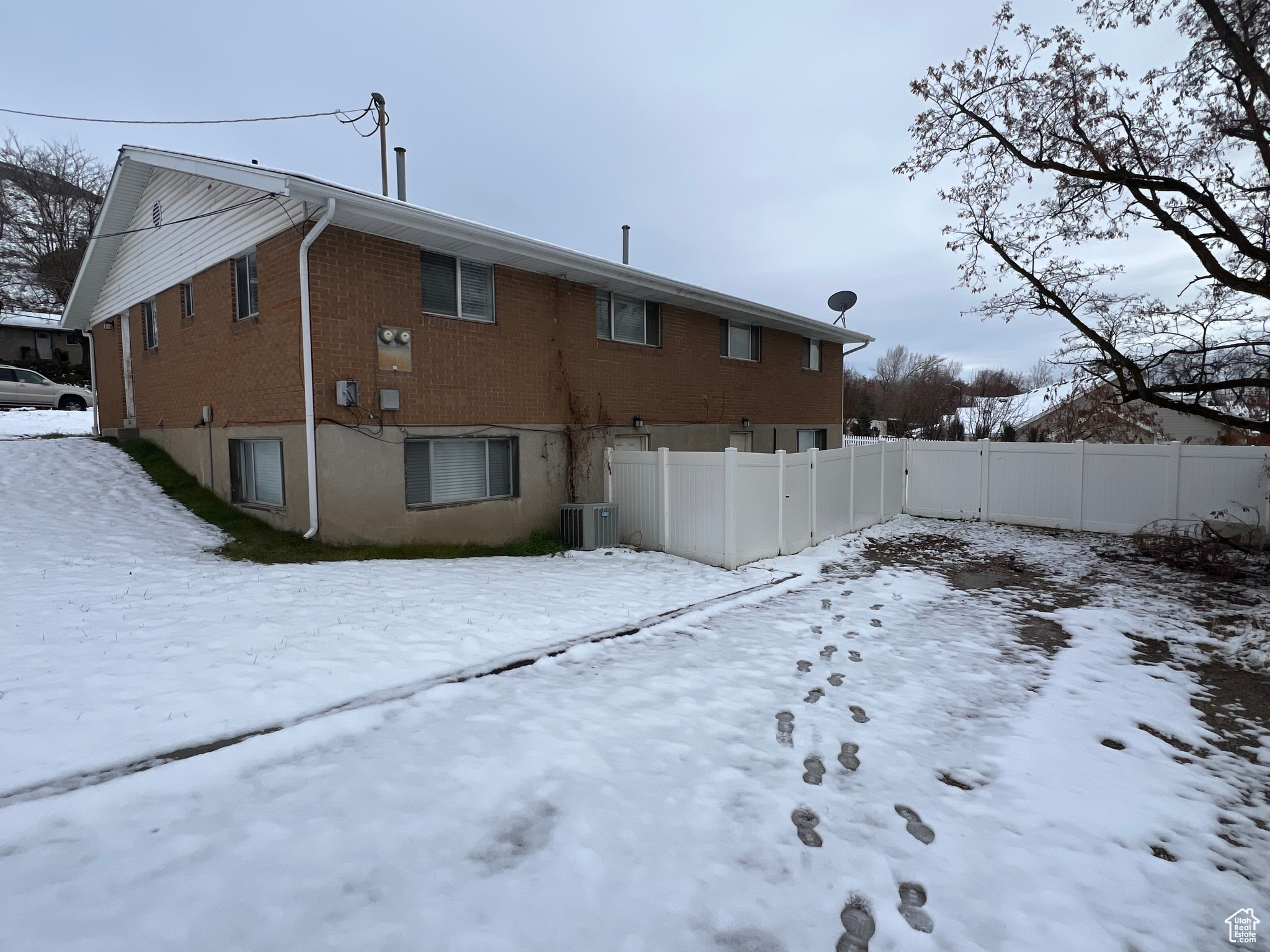 Snow covered property featuring central AC unit