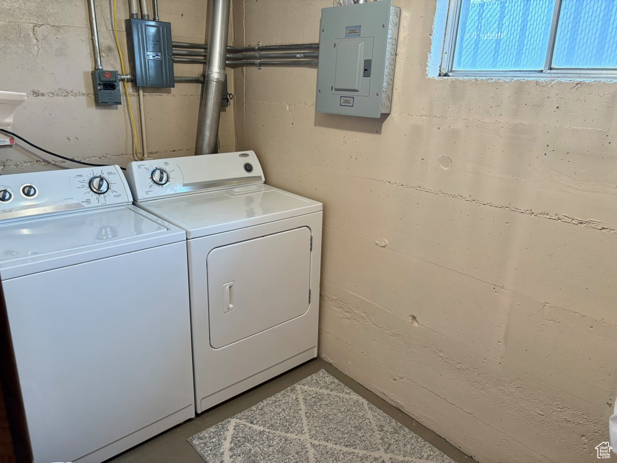 Washroom with electric panel and washer and dryer