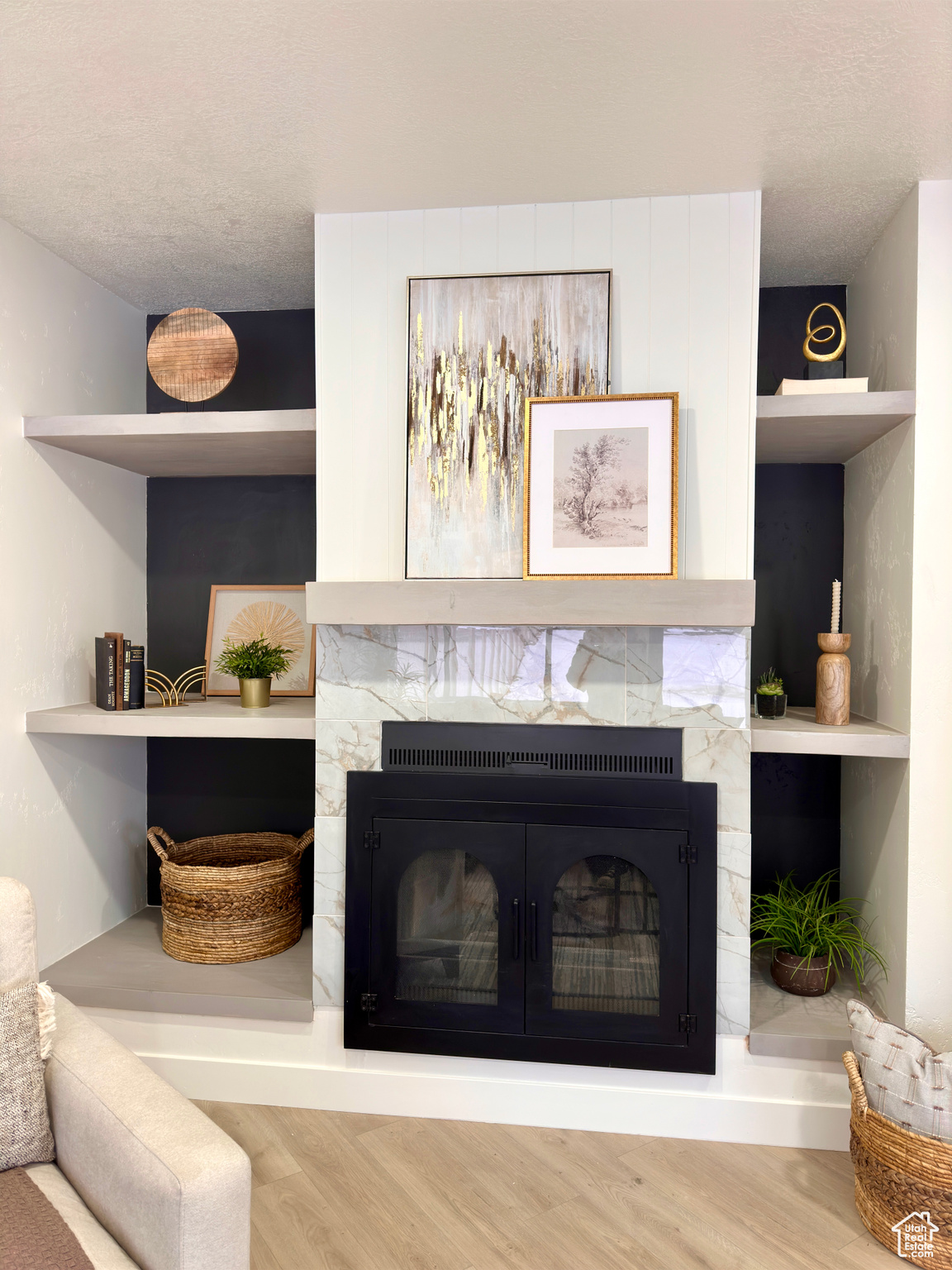 Interior details with a fireplace, built in shelves, and wood-type flooring