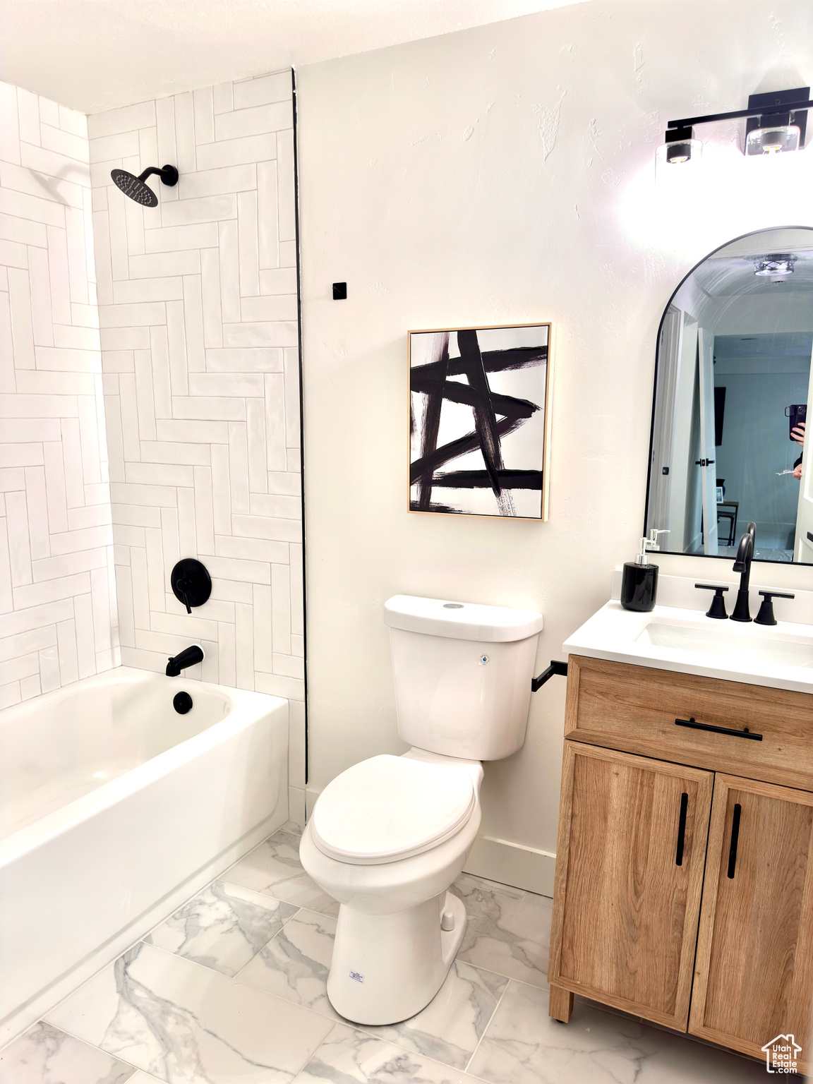 Full bathroom featuring toilet, vanity, and tiled shower / bath