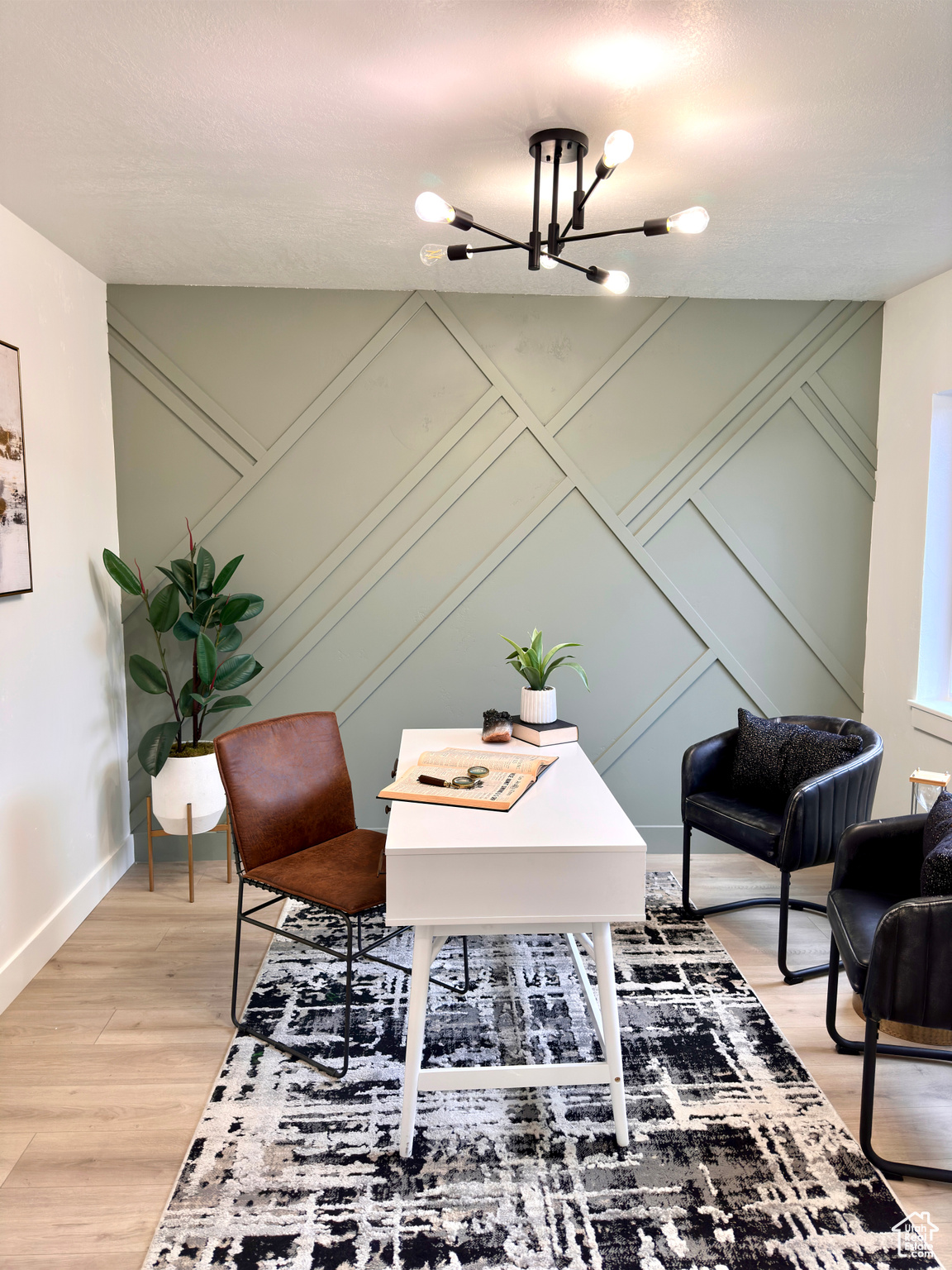 Home office featuring hardwood / wood-style floors and an inviting chandelier