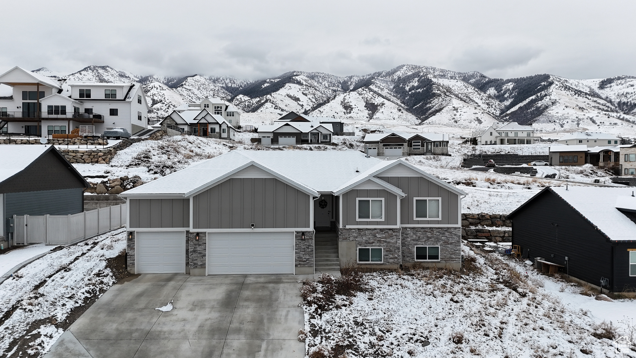 View of front of home featuring a mountain view and 4 car garage