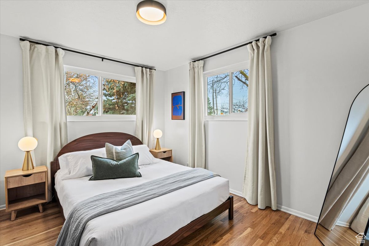 Bedroom with hardwood / wood-style floors