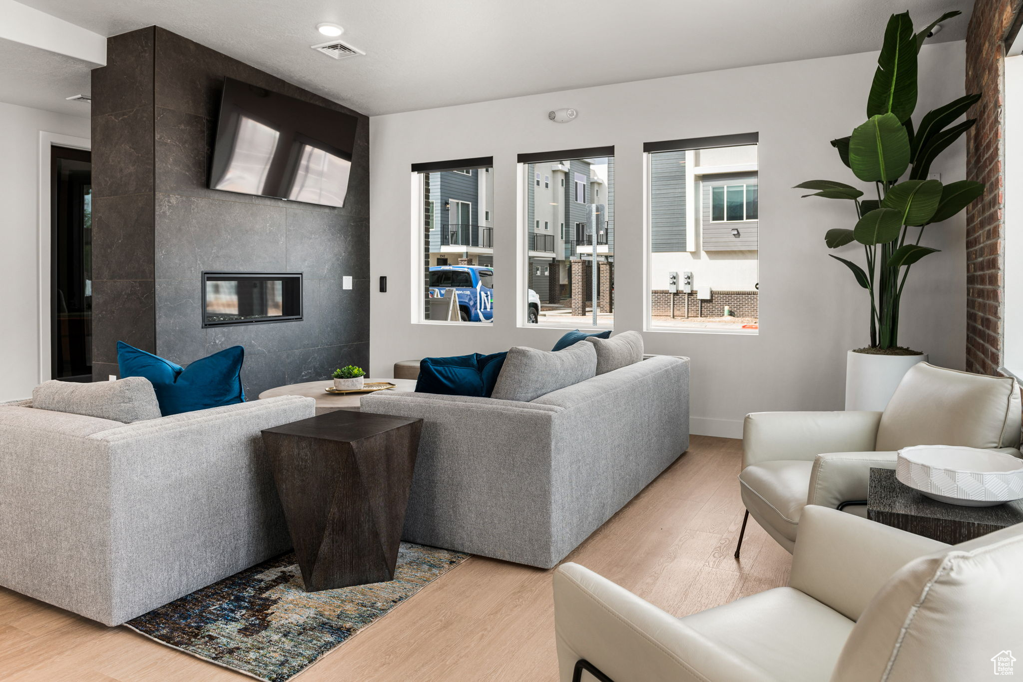 Living room with a fireplace and hardwood / wood-style floors