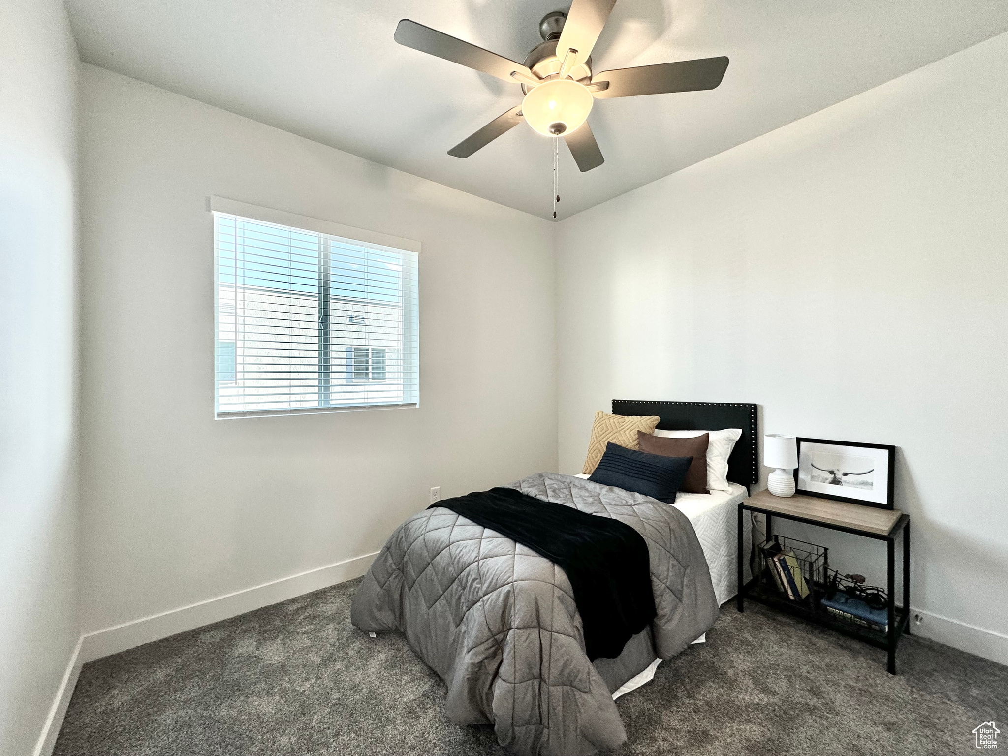 Carpeted bedroom with ceiling fan