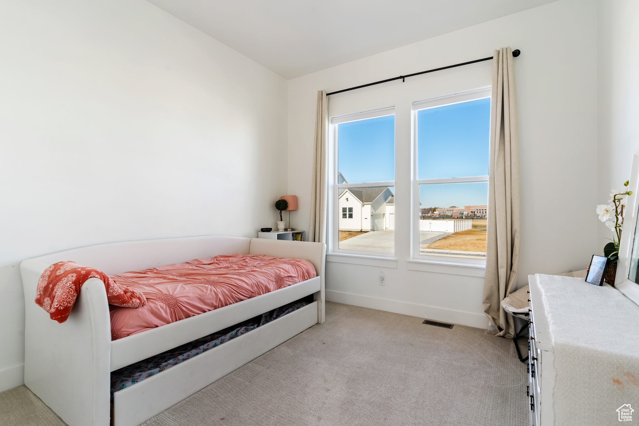 Bedroom with light colored carpet