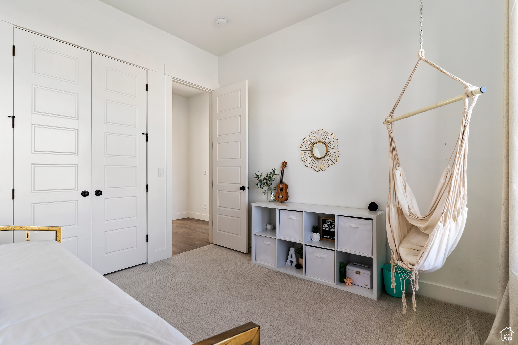 Carpeted bedroom with a closet