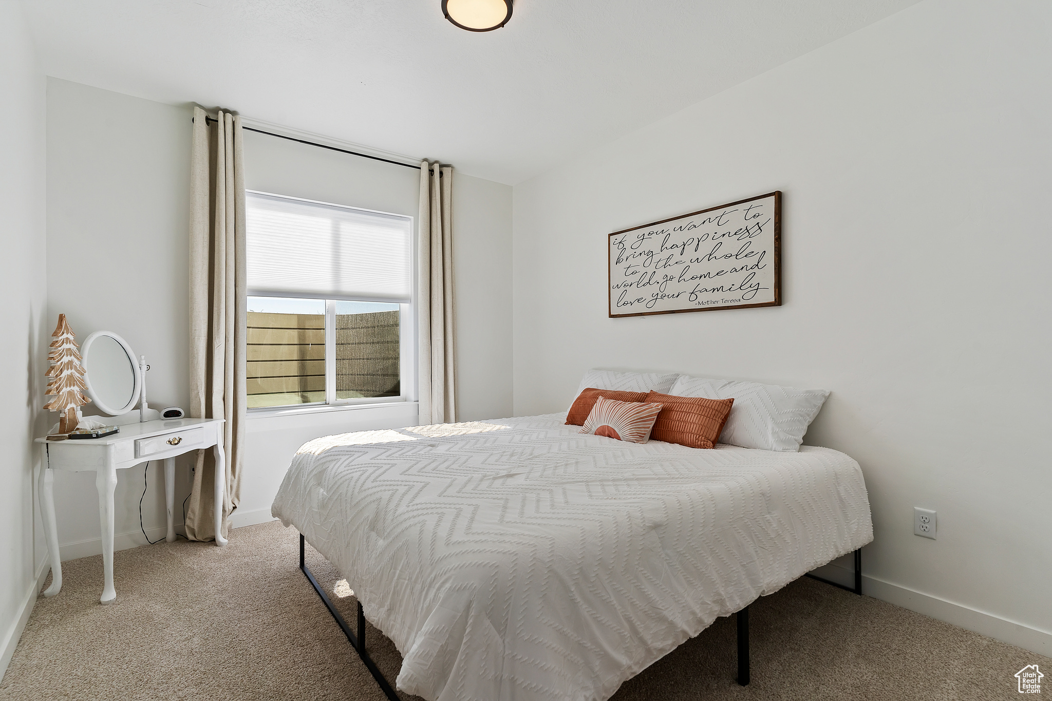 Bedroom with light colored carpet