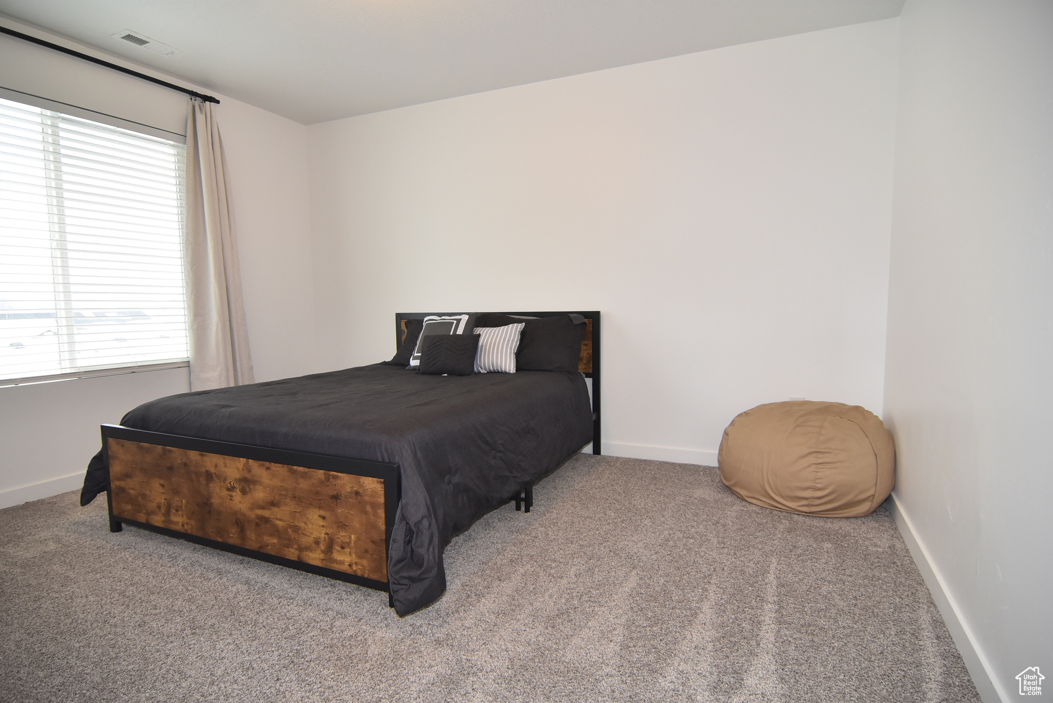 Bedroom #3 with carpet flooring and view window.