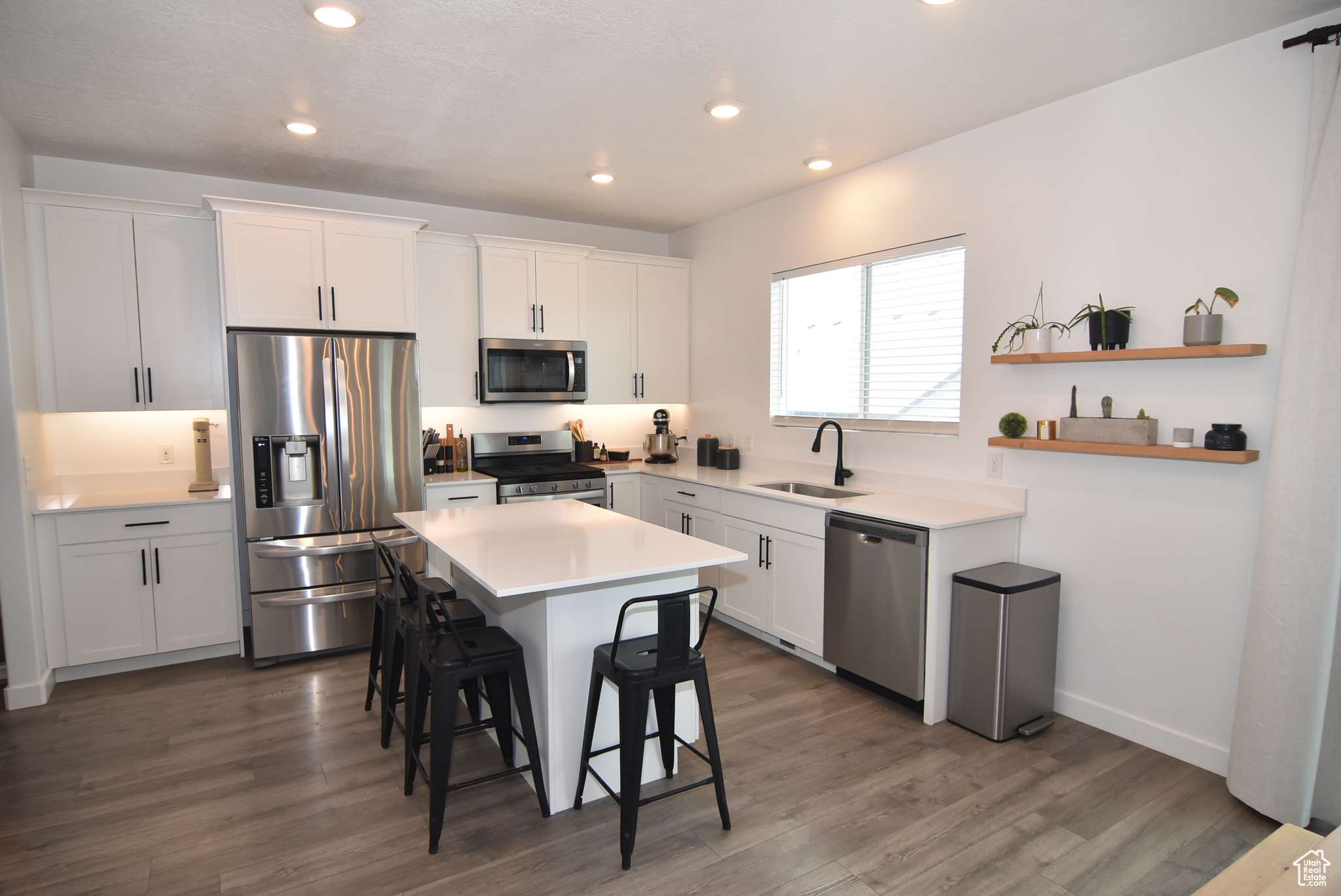 Kitchen with center island and quartz counter tops.